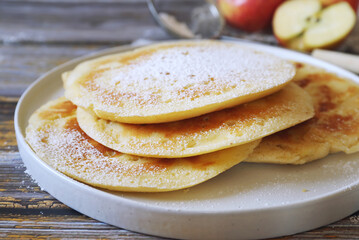 Sweet Apple Pancakes, powdered sugar dressing and red apples