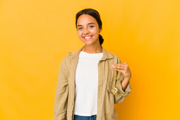 Young hispanic woman holding a pocket watch happy, smiling and cheerful.