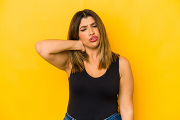 Obraz premium Young indian woman isolated on yellow background suffering neck pain due to sedentary lifestyle.