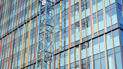 View of a skyscraper under construction. Modern architecture background. Building a high-rise building,  the concept of real estate construction. 