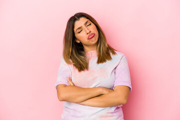Fototapeta premium Young indian woman isolated on pink background tired of a repetitive task.