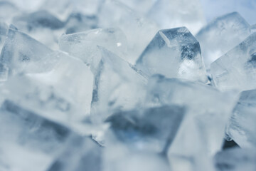 close-up of ice cubes in freezer tray with cold blue tones