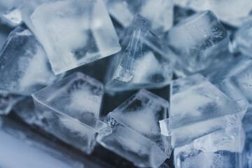 close-up of ice cubes in freezer tray with cold blue tones