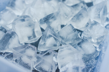 close-up of ice cubes in freezer tray with cold blue tones