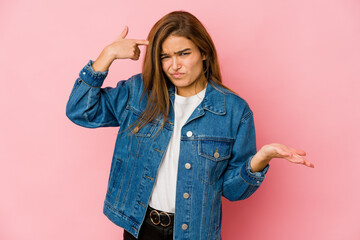 Young skinny caucasian teenager girl showing a disappointment gesture with forefinger.