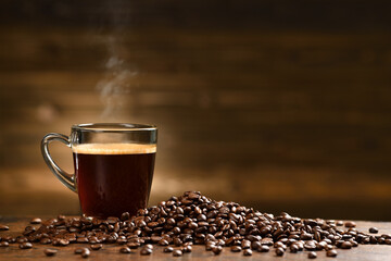 Cup glass of coffee with smoke and coffee beans on old wooden background - Powered by Adobe
