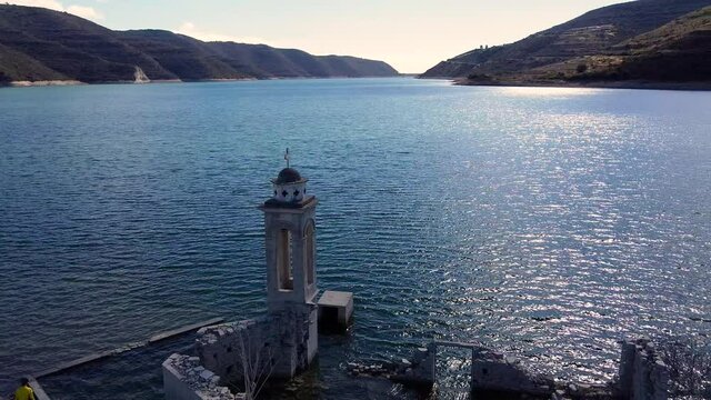 View of the bell tower of the famous underwater St. Nicolas Church inside the Kourris Dam, Cyprus.