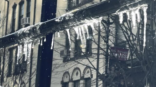 icicles hanging from metal pole snowing in winter in New York City NYC
