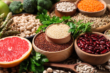 Fresh vegetables, grapefruit and seeds on wooden table, closeup