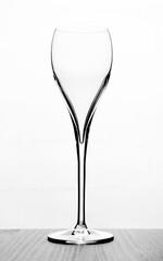 Naklejka premium Transparent tall wine glass on a light background