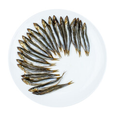 smoked herring, laid out in a circle on a white round plate. Isolated on a white background