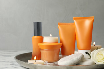 Composition with cosmetic products on white marble table