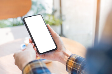 cell phone blank white screen mockup.woman hand holding texting using mobile on desk at office.background empty space for advertise.work people contact marketing business,technology
