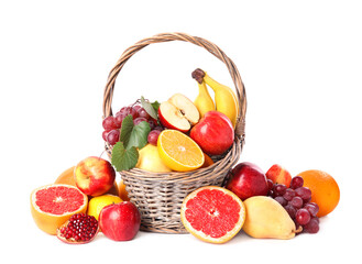 Wicker basket with different fruits on white background