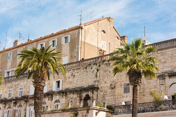 Fototapeta na wymiar Croatia, Split. Balconies on outside wall Diocletian's Palace on Riva. Man in window.