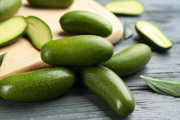 Fresh seedless avocados on grey wooden table, closeup