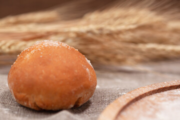 bun close-up against the background of wheat ears, postcard, place under the text, copy space