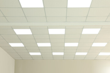 White ceiling with lighting in office room