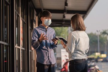 New normal, People wear facemask protect coronavirus talking business by tablet technology