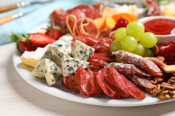 Plate of different appetizers with dip sauce on white table, closeup