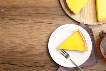 Delicious homemade lemon pie on wooden table, flat lay. Space for text