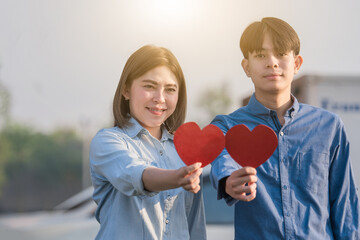 Asian couple holding red heart ,People happy sweet love Valentine, health  insurance , Giving Love together