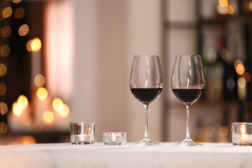 Glasses of wine for romantic dinner on table in restaurant