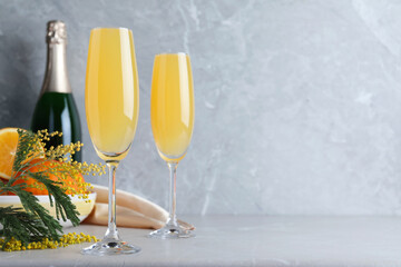 Glasses of Mimosa cocktail on light table. Space for text © New Africa