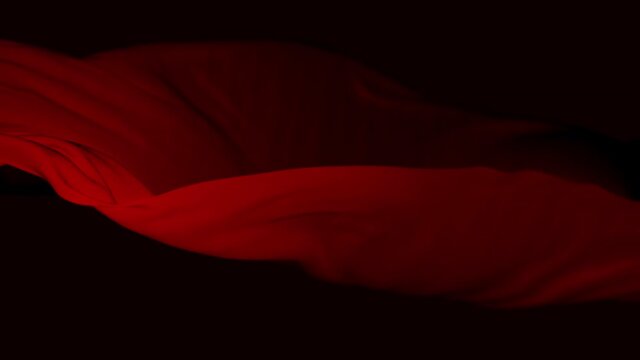 4k Red wave satin fabric loop background.Wavy silk cloth fluttering in the wind.tenderness and airiness.3D digital animation of seamless flag waving ribbon streamer riband.