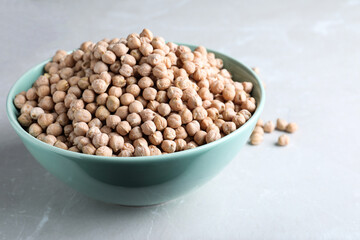 Chickpeas in bowl on light table. Natural food