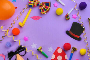 Frame made of clown's accessories on violet background. Space for text