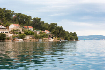 Croatia, Brac Island, Bobovisca. Paddleboarders on calm water.