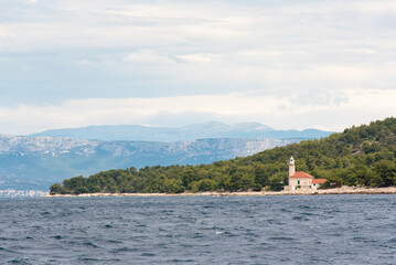 Fototapeta na wymiar Croatia. Lighthouse Brac Island, mainland and Dinaric Alps behind.