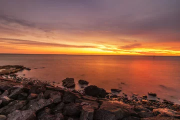 Fotobehang sunset over the sea © Morrie