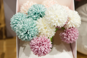 Ballpoint pens in the form of flowers on a shop counter. Bright, unusual stationery goods.
