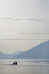 Boats on the reservoir lake and mountains in the distance
