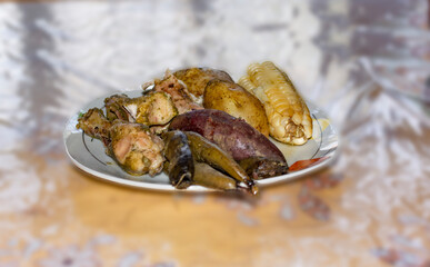 Chicken with meat, potatoes and beans in a pachamanca