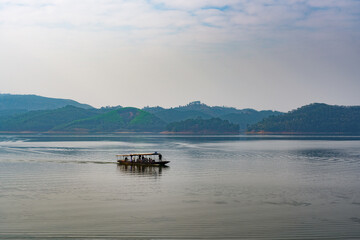 Boats on the reservoir lake and mountains in the distance