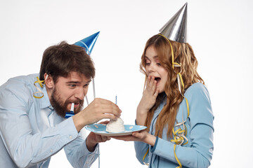 Joyful man and cheerful Woman holiday cake Birthday cap party corporate party young people