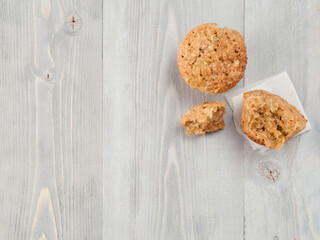 Top view of muffin with zucchini, carrots, apple and cinnamon on gray wooden background. Sweet vegetables homemade muffins. Toddler-friendly recipe idea. Copy space. Shallow DOF