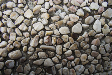 decorative coating of natural small stones of different shapes in gray tones for the background