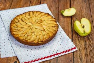 Homemade Russian apple pie (Sharlotka) on a wooden table. 