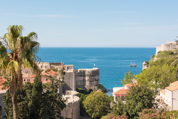 Croatia, Dubrovnik. Fort Bokar Pile Gate defense walled city. Sailboat on Adriatic Sea.