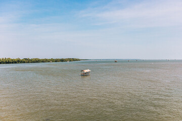 Small hut in the middle of the sea to guard the fishing net area in Thailand.