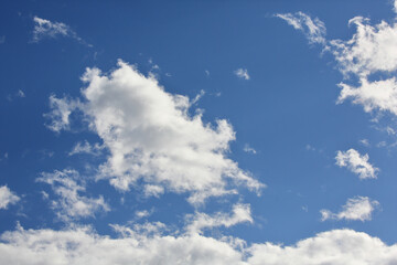 Deep blue sky and fluffy clouds.