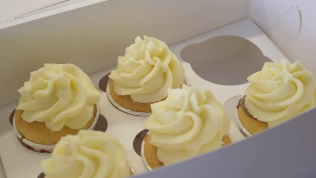 Girl Baker Prepared Pastries. Small Box with Sweets. Takeout Order. Custard Cream and Shortcakes with Chocolate Filling. Penultimate Cake Puts in Box. Packaging. Sweets. Yummy. Bakery. Work. Close-up