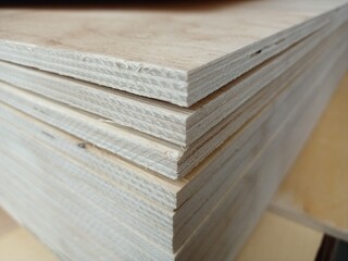 A stack of plywood sheets for construction. A pile of wooden chipboard sheets. Osb plywood.
