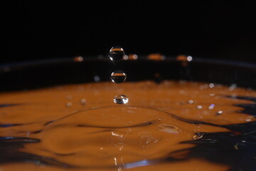 splash of water after falling drops, stop motion, dripping water into a glass
