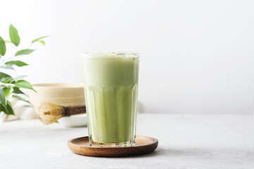 A glass of matcha tea on a concrete background with  copy space.