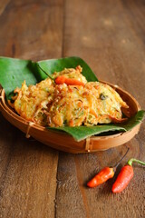 bakwan or vegetables fritter  in a woven bamboo plate on the table